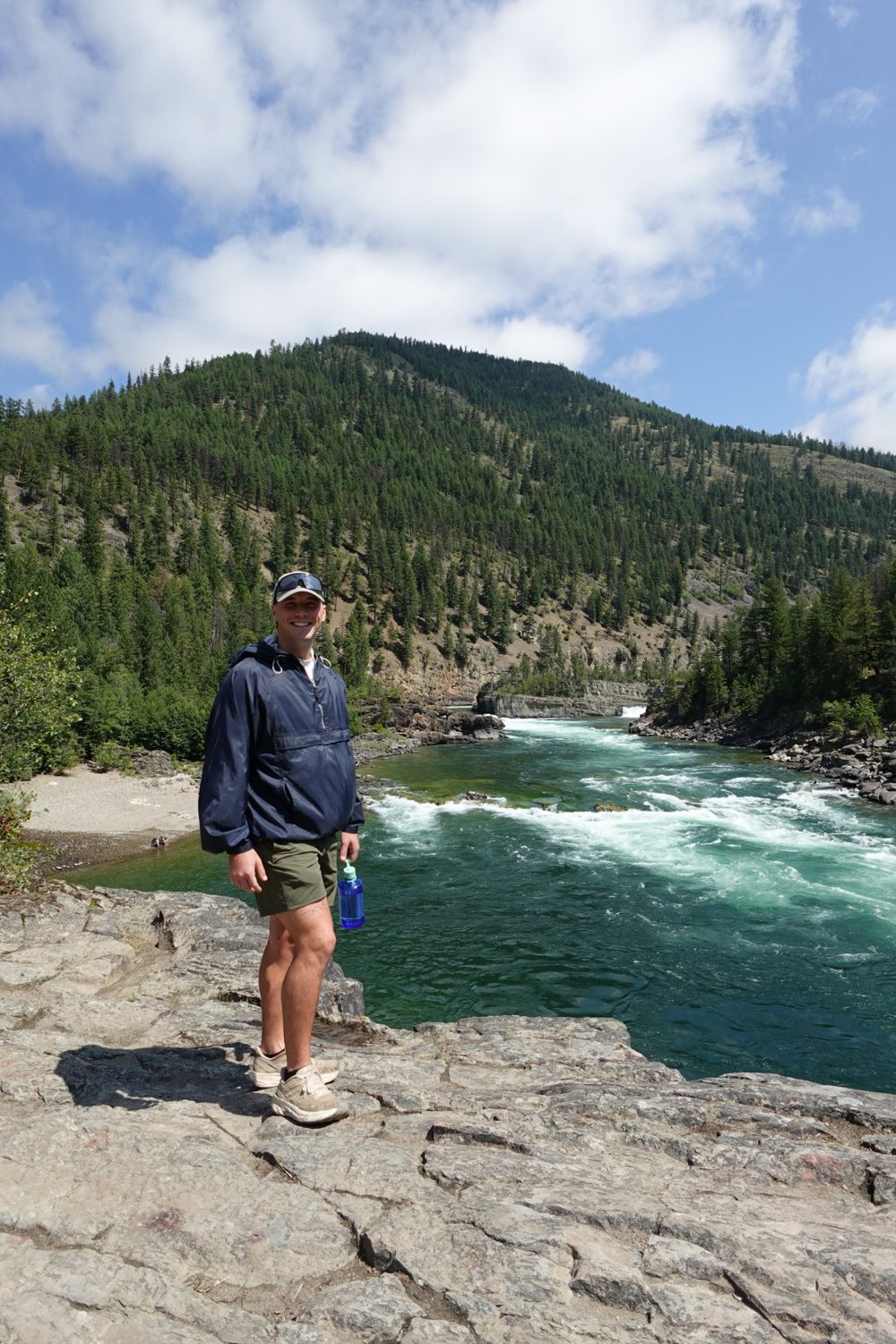 Josh, founder of Aaron Meadow Marketing, hiking by a river